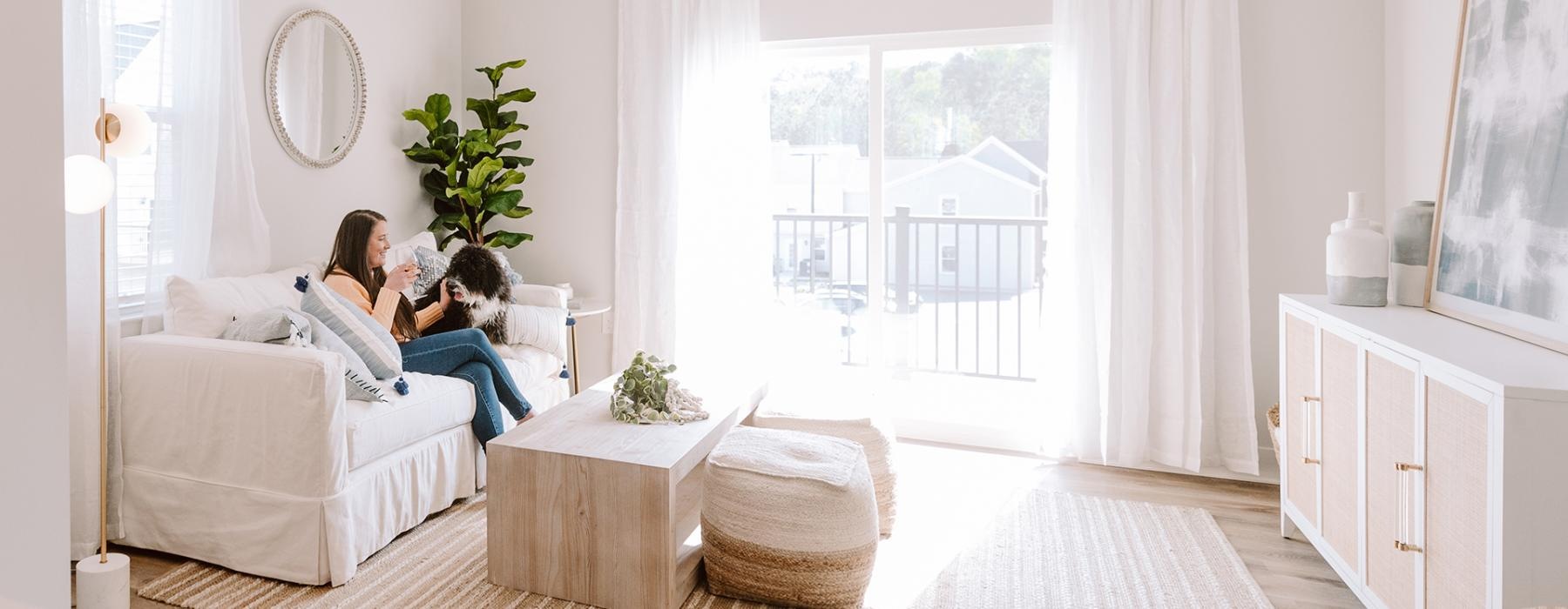 a person and a child sitting on a couch in a living room