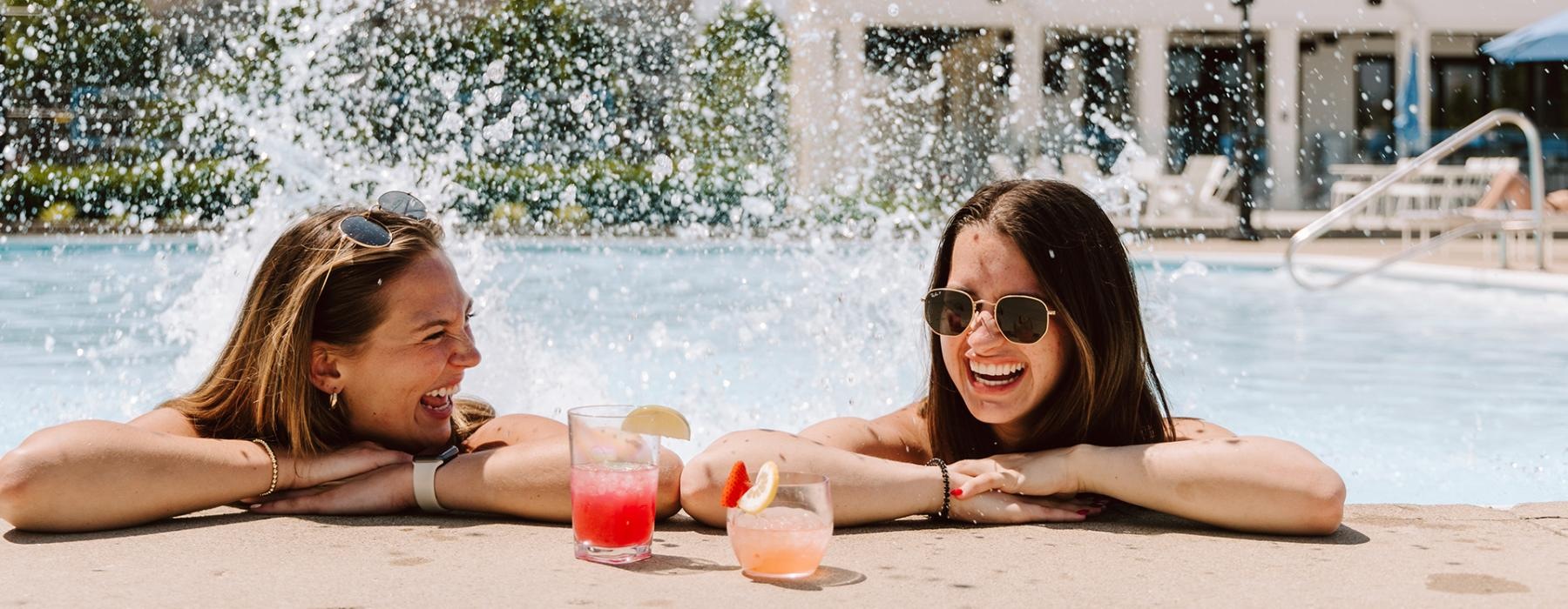 two women lying in a pool