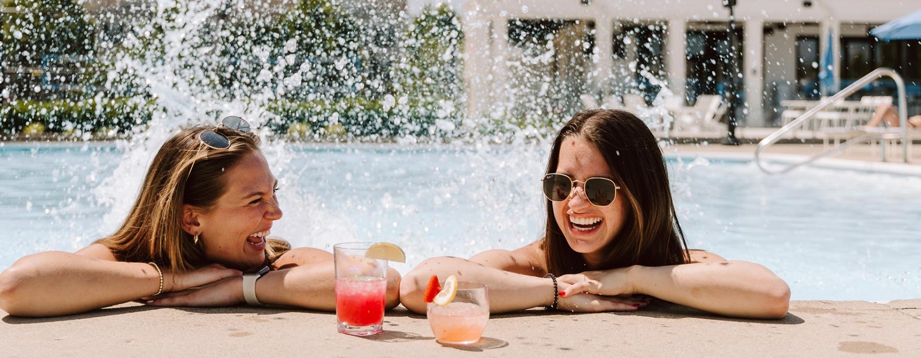 two women lying in a pool